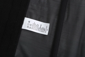 Detailed fabric care label on black satin lace lingerie showing material composition and size M