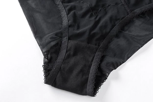 Vue macro détaillée d'une culotte en dentelle noire avec broderie et doublure en coton