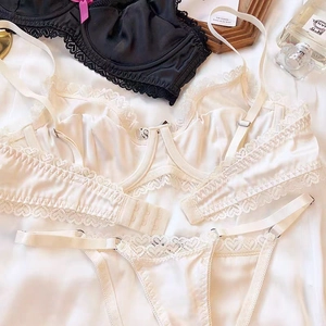Detailed view of ivory satin lace bra with multi-hook closure and adjustable straps