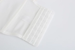 Detail shot of white 4-row 5-hook bra extender with breathable mesh fabric texture