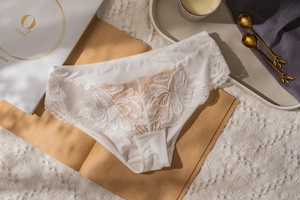 Detailed macro shot of French white floral lace underwear on an elegant background