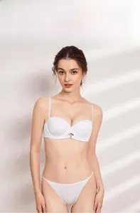 Detailed view of white seamless strapless bra with smooth fabric and central metal clasp