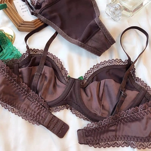 Detail of satin lace bra featuring heart patterns and three-row hook and eye closure