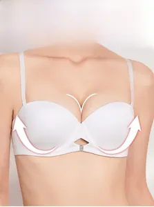 Close-up of seamless white half-cup bra with rhinestone cross-hollow detail and thin straps