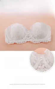 Detailed view of white floral lace bra featuring bunny ear inserts and lace-up front detail