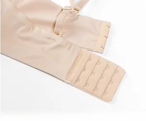 Detail of nude seamless bra featuring wide non-slip side wings and multi-row hook eye closures