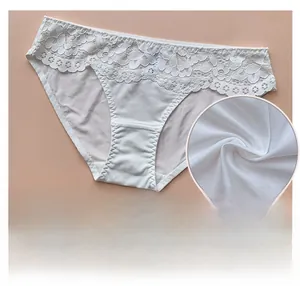 Detail view of breathable white cotton fabric and delicate floral lace on women underwear