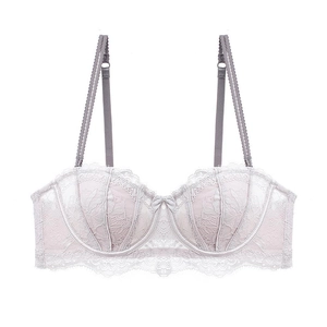 Detailed view of pale pink floral lace bra with scalloped edges and delicate bow