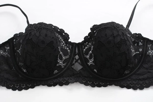 Close-up of elegant black floral lace details and fine embroidery on this sexy bra