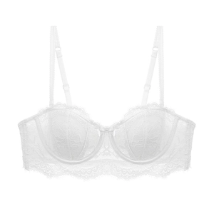 Detailed macro view of white floral lace texture and bow knot on the half cup bra