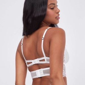 Detail of white eyelash lace bustier featuring back multi-hook closure and adjustable straps