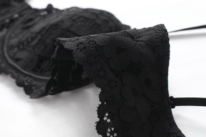 Detailed macro view of delicate black floral eyelash lace embroidery on a bra