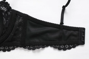 Detail view of lace bra back closure with three-row hooks and adjustable straps