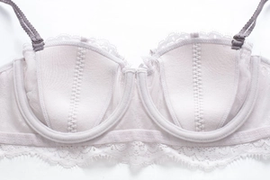 Detail view of light purple lace bra featuring scalloped edges and breathable mesh fabric