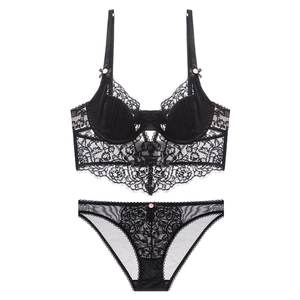 Detailed flat lay of black eyelash lace lingerie set with pink floral accents