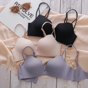Close-up of seamless push-up bras with thin double straps in black, beige, and lavender