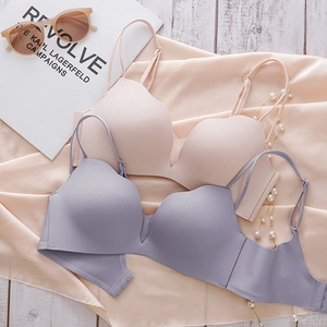 Detail of seamless wireless bras with wave-cut edges in skin pink and light purple