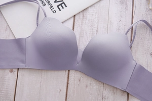 Detail of lavender seamless bra showing scalloped wavy edges and smooth elastic fabric
