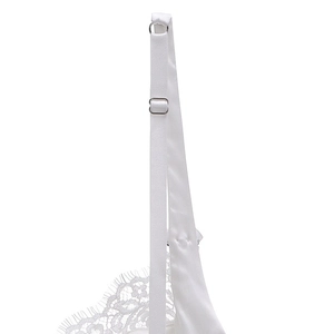 Detailed close-up of white eyelash lace embroidery and adjustable thin satin straps