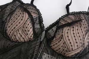 Detail of French lace bra featuring front buckle closure and black floral embroidery