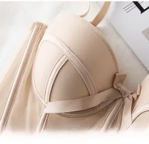 Close-up of nude push-up corset bra with crisscross straps and side bow detail