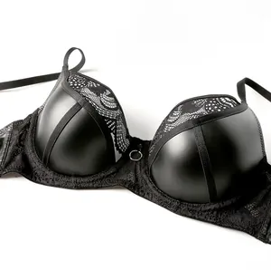 Detail of sexy black PU leather and lace bra featuring a central silver metal ring ornament