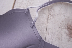 Detail view of purple seamless bra with reinforced thin shoulder strap connections