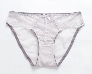 Detailed view of pale lavender lace panties with floral embroidery and bow detail