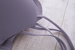 Detailed close-up of light purple seamless bra featuring triple thin shoulder straps