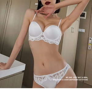 Nahaufnahme von weißem Spitzen-Dessous-Set mit Satin-Cups und gewellten Spitzenkanten