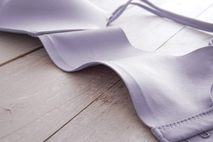 Detail of lavender seamless bra showing smooth elastic fabric and sleek wing edge