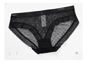 Detailed macro view of black mesh polka dot lace panties with three thin waist straps