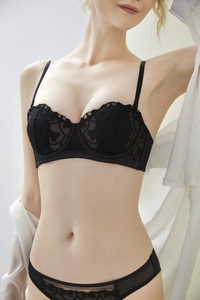 Detail of black lace embroidery lingerie set with delicate butterfly patterns on sheer mesh