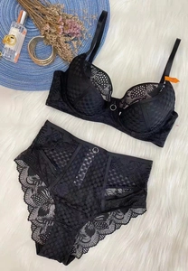 Detailed flat lay of black lace bra and panty set with 75B size tag on plush background