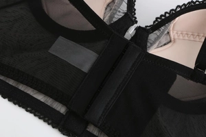 Detail of black lace bra showing intricate embroidery and breathable honeycomb mesh fabric