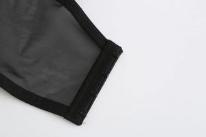 Detail of multi-row hook-and-eye back closure on black mesh lace bra with reinforced edges