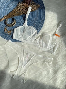 Detail shot of white lace embroidery lingerie set with floral mesh and 75B size tag