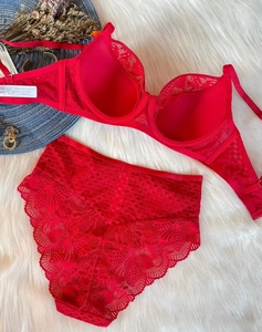 Flat lay of red floral lace lingerie set with high-waist panty on white faux fur