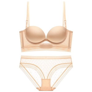 Seamless beige lingerie set with a push-up bra and matching polka dot lace panties