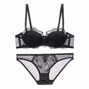 Flat lay of black lace lingerie set featuring detailed embroidery and mesh paneling