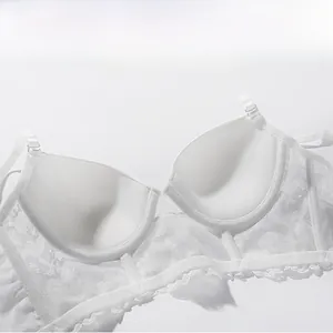 Detail view of white lace bra featuring soft thick bottom mold cup for push-up effect