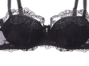 Detail of black French lace bra with floral embroidery and center crystal pendant