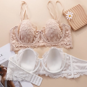 Close-up of floral lace bras in beige and white featuring supportive underwire and bow