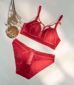 Detailed view of red wireless lace bra set with crisscross straps and 75B size tag