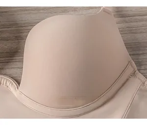 Detailed close-up of smooth seamless cups and stitching on the beige U-shaped plunge bra