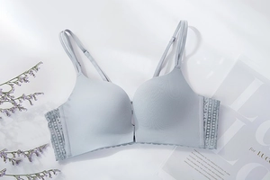 Detail of light blue seamless bra with elegant lace trim and slim double straps
