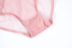Detail of pink mesh lace panties showing high-quality stitching and breathable fabric