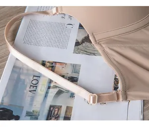 Detail of adjustable thin straps and seamless stitching on a beige backless bra