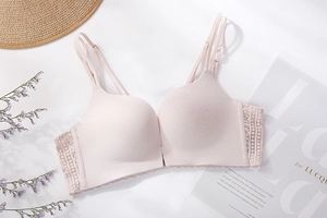 Detail view of pink seamless wireless bra with floral lace wings and thin straps