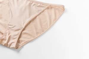 Close-up of seamless skin-tone briefs showing delicate fabric texture and flat seams